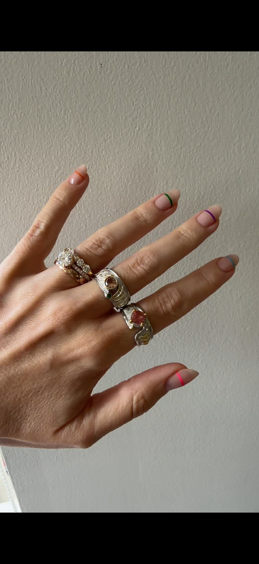 Heartfire and Cognac Hour rings being worn on hand, pink tourmaline and sterling silver wide band, Kismet Society fine jewelry