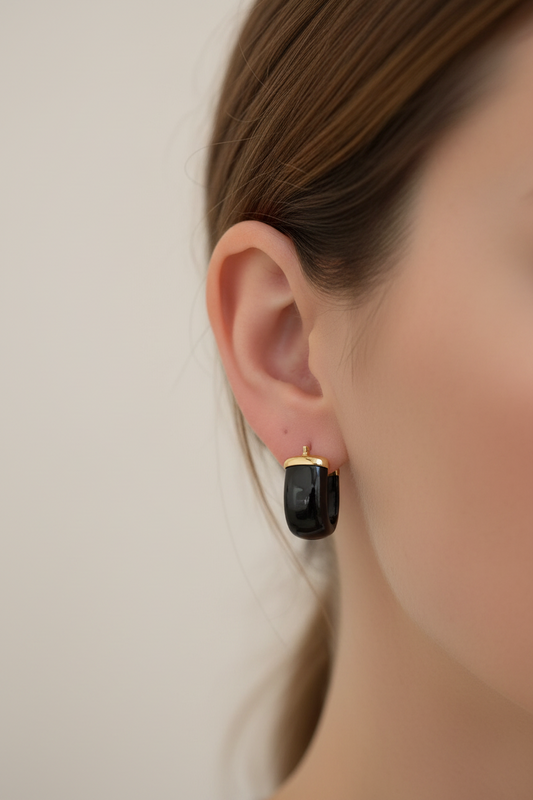 Close up of The Noir chunky black onyx hoop earring worn on model, white studio background, Kismet Society fine jewelry