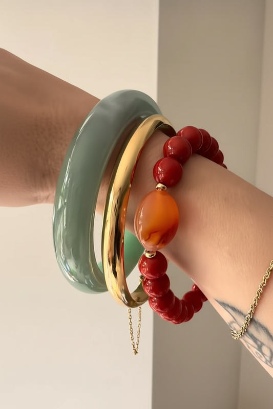 Close up of The Sundowner red coral and carnelian stretch bracelet worn on wrist, Kismet Society fine jewelry